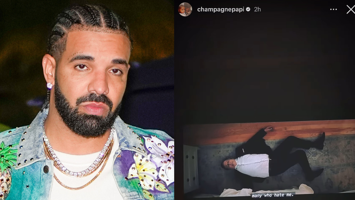 Drake wearing a denim jacket with butterfly designs and chains, posing for the camera