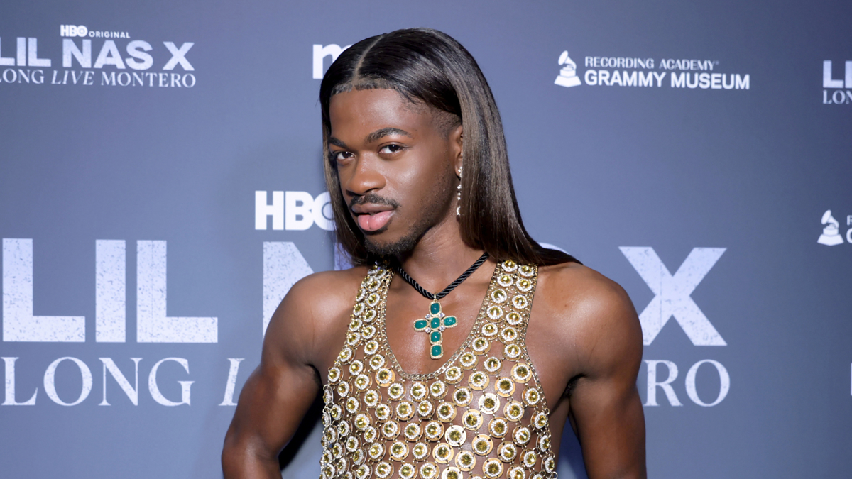 Lil Nas X poses in a patterned sleeveless top with a turquoise necklace at the 'Long Live Montero' event