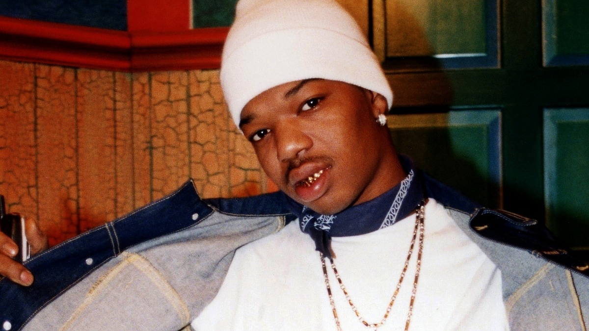 Man in beanie and denim jacket with jewelry