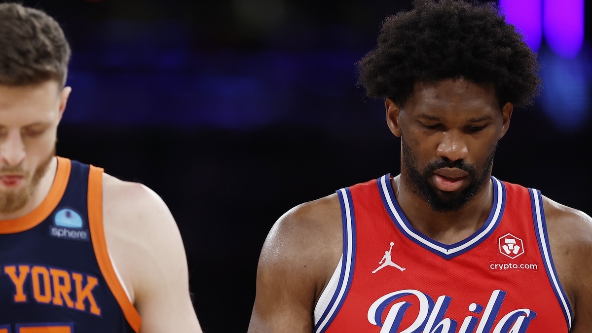 Two basketball players, one from New York and another from Phila, walking down the court