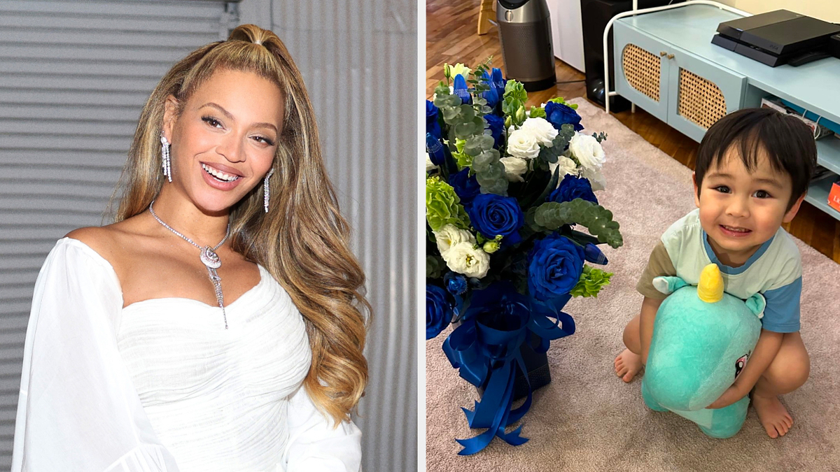Person on left smiling in an elegant off-shoulder dress and necklace. Child on right holding a stuffed toy, standing next to flowers