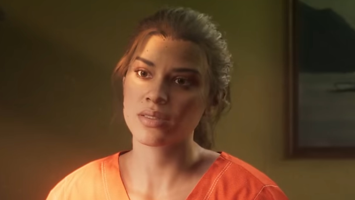 Woman in orange prison attire sitting, looking concerned. Appears in a drama scene