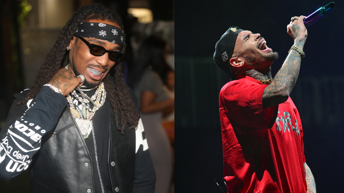 Two artists expressively performing on stage, one in a monochrome outfit, the other in red with a mic