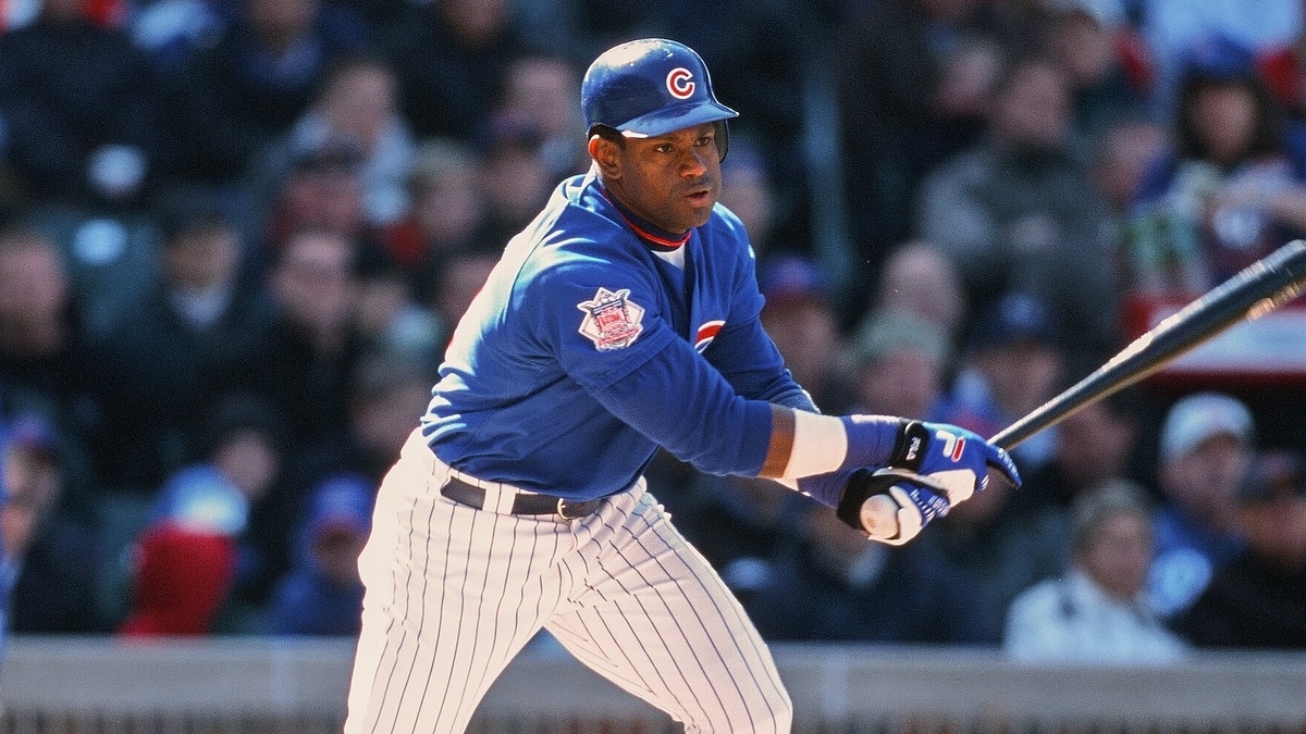 Baseball player in action during a game, wearing a Chicago Cubs uniform and swinging the bat