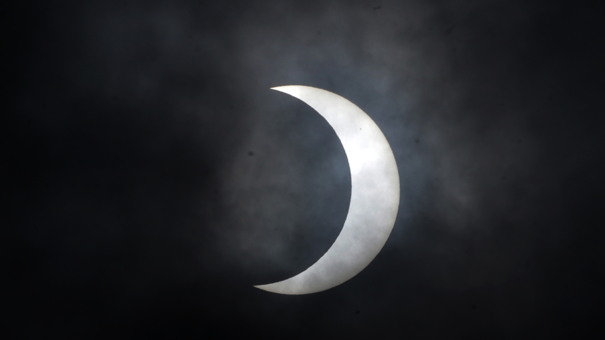 Partial solar eclipse against a dark sky