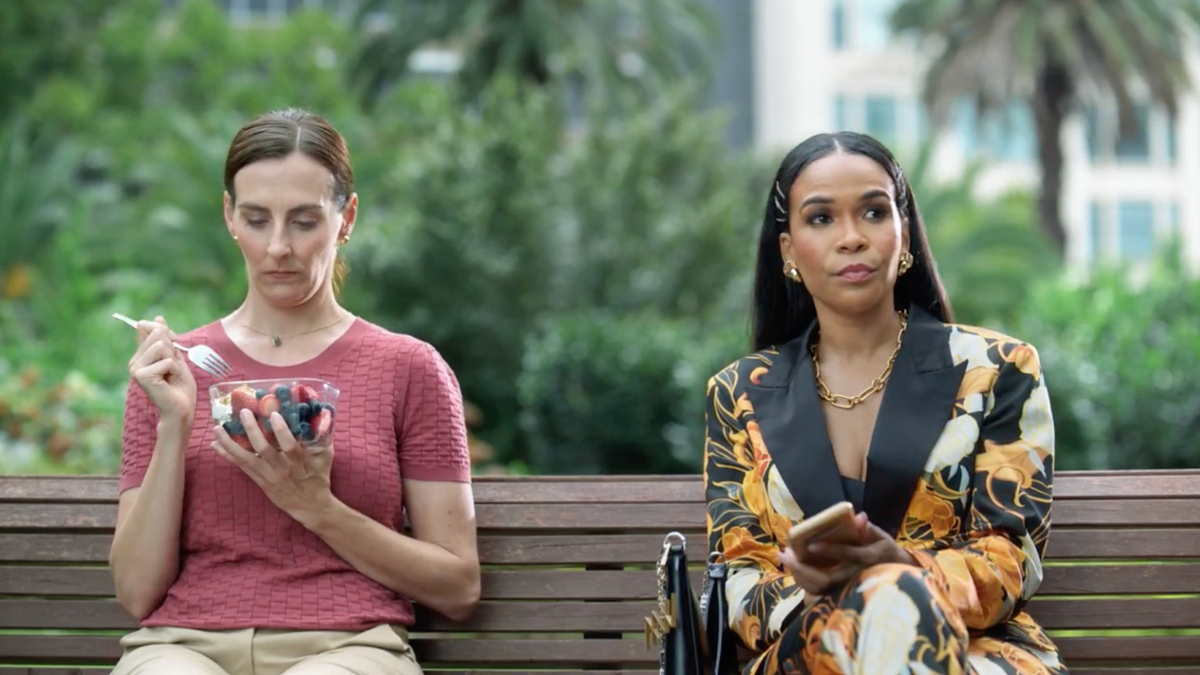 michelle williams on a park bench