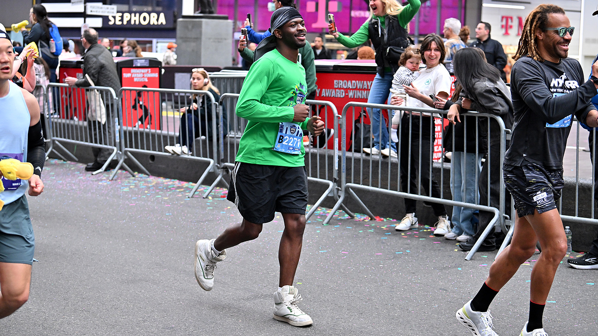 Runners in an urban marathon event, wearing athletic gear and sneakers, focused and enjoying the race