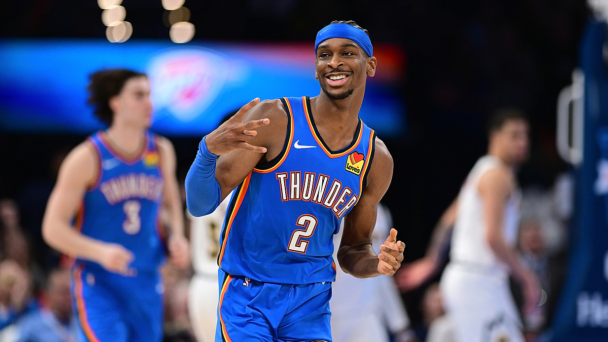 Basketball player in Thunder jersey gestures on court with focus on him