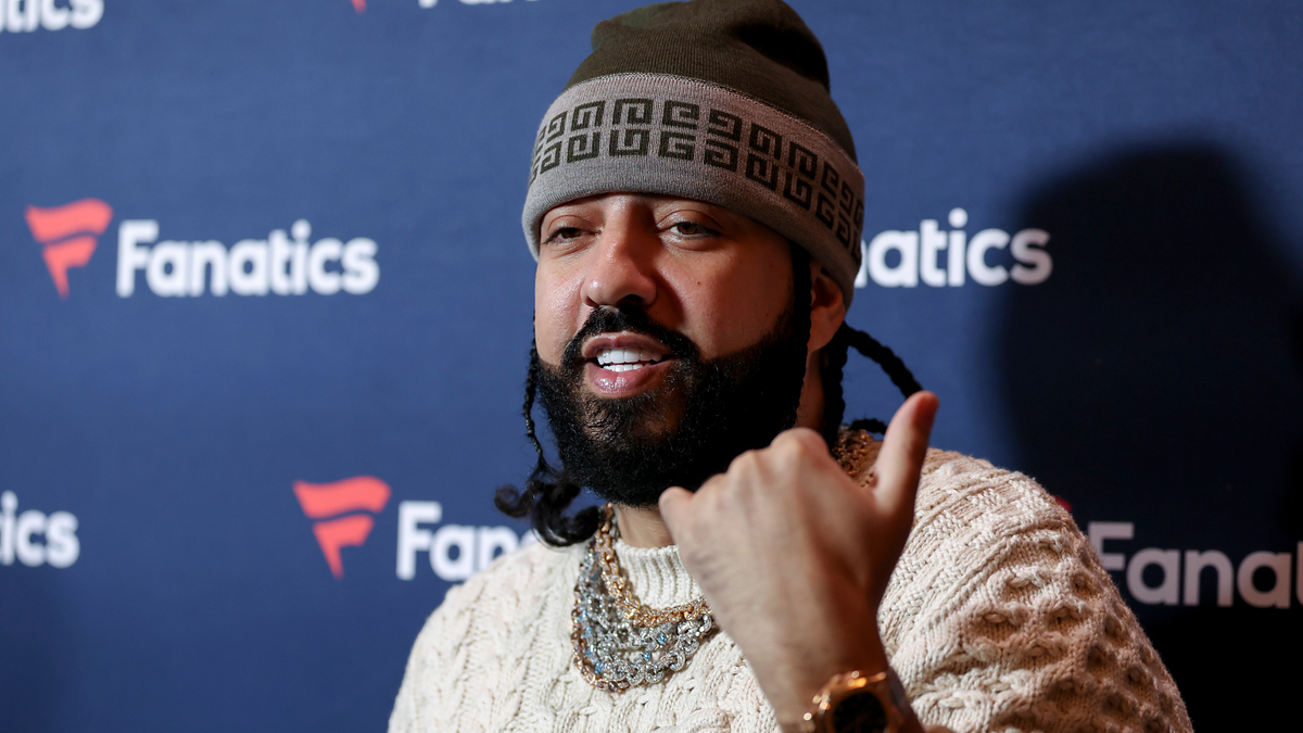 Man in beanie gives thumbs-up at Fanatics event