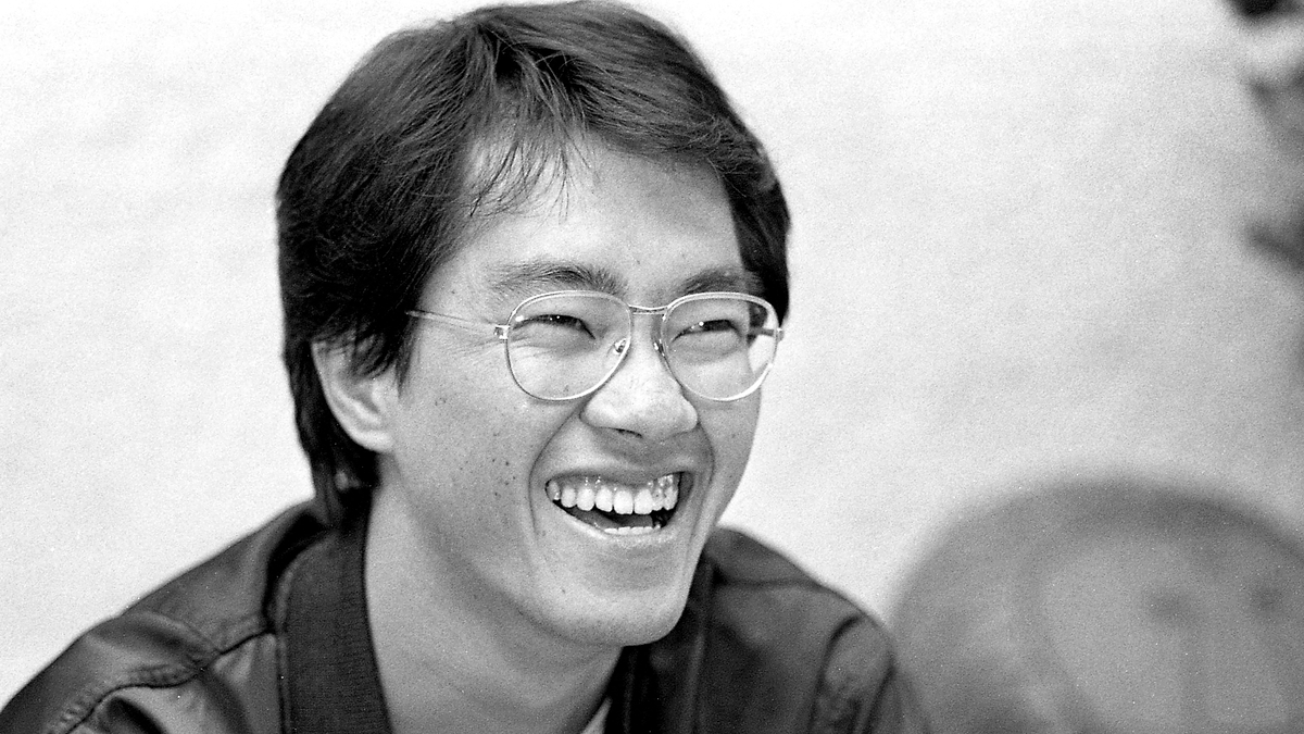 Smiling person with glasses, wearing a leather jacket