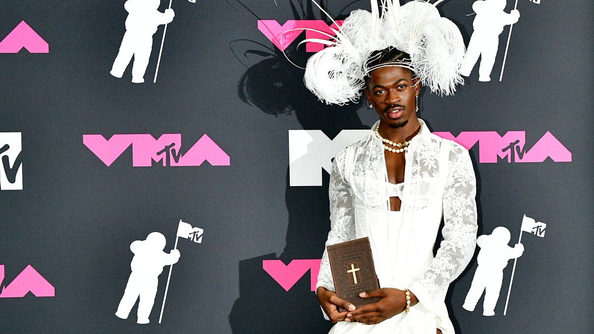 lil nas x holds a book