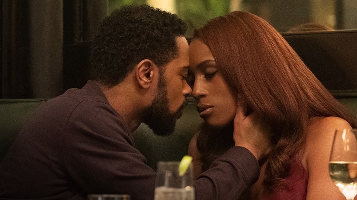 Two characters in an intimate moment at a table, likely from a film or TV scene; black romance movies