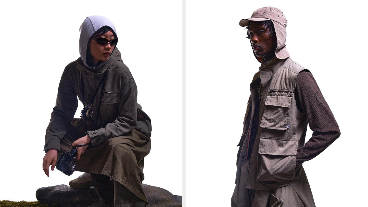 Two models in utilitarian outfits with multiple pockets, one squatting, one standing