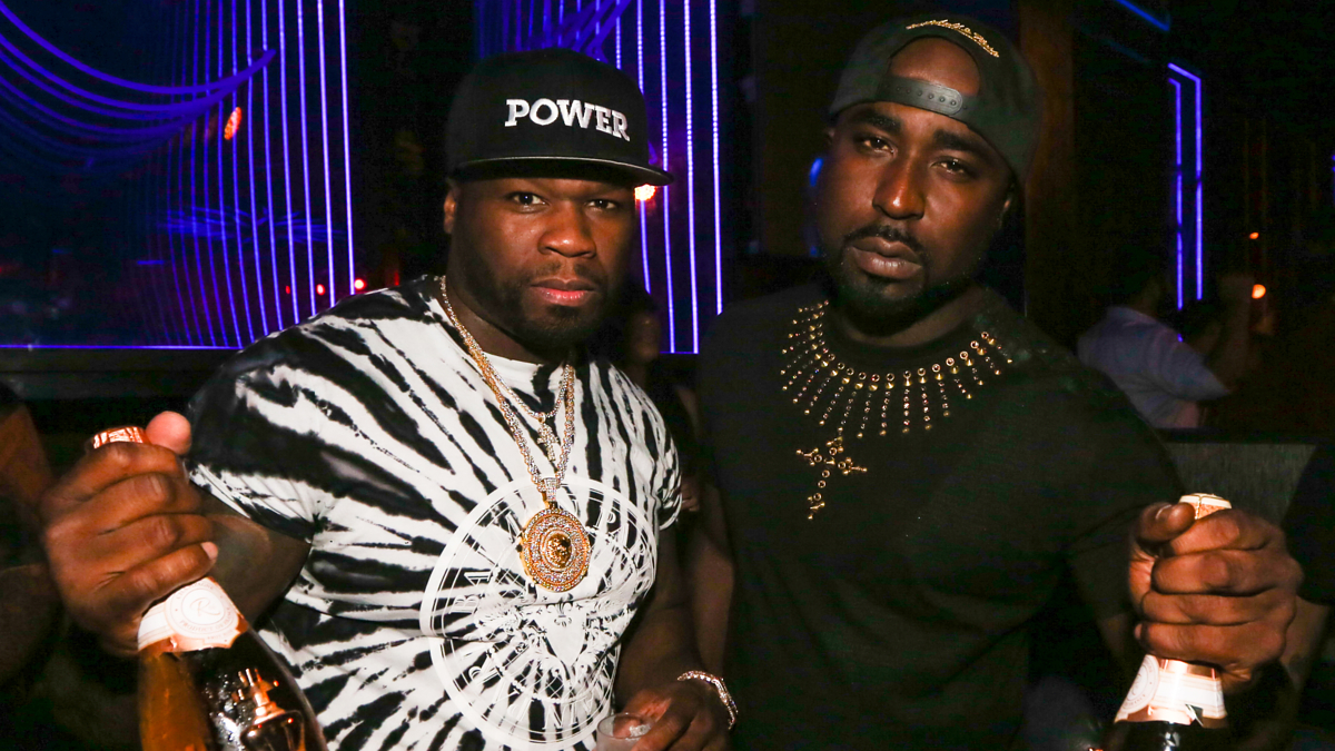 50 and buck are seen at a power event