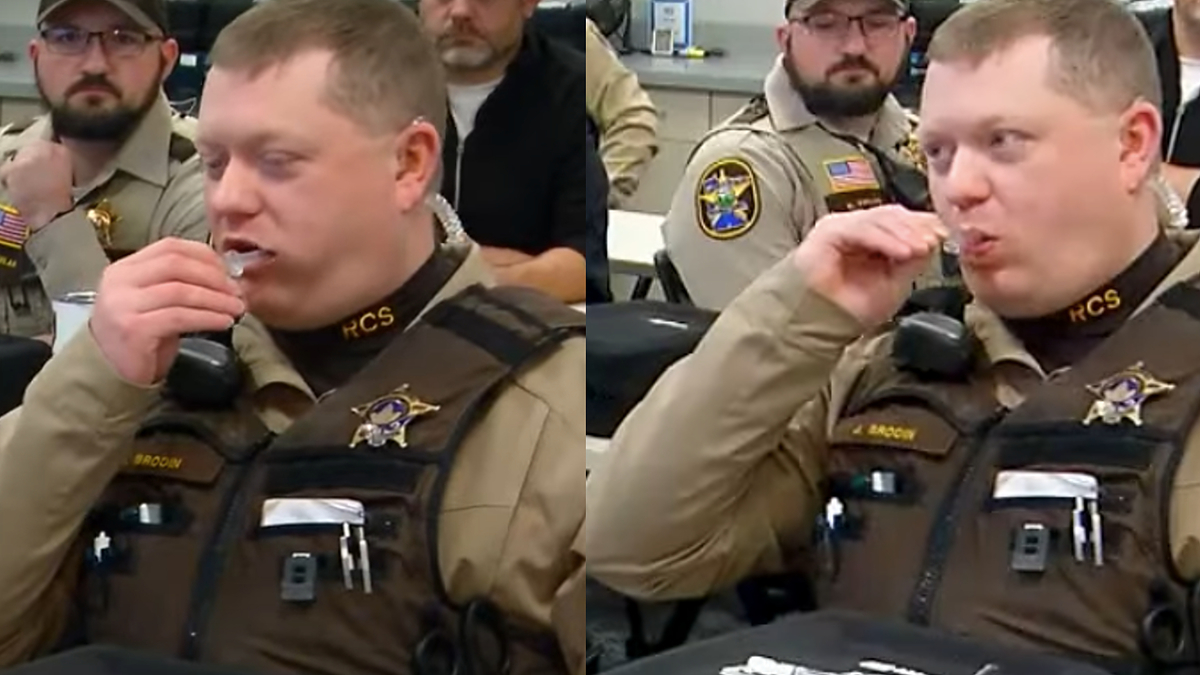 a cop is pictured sucking on a tube