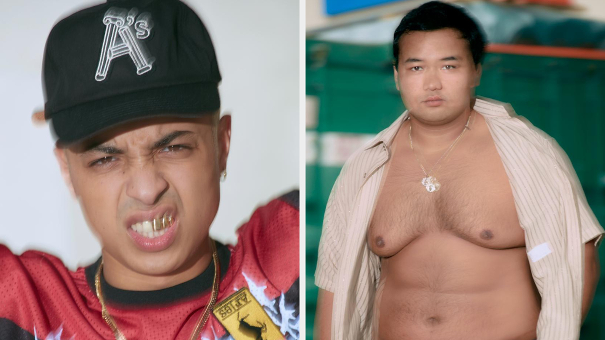 Person on left in cap making a face, person on right shirtless, wearing open white shirt and pants