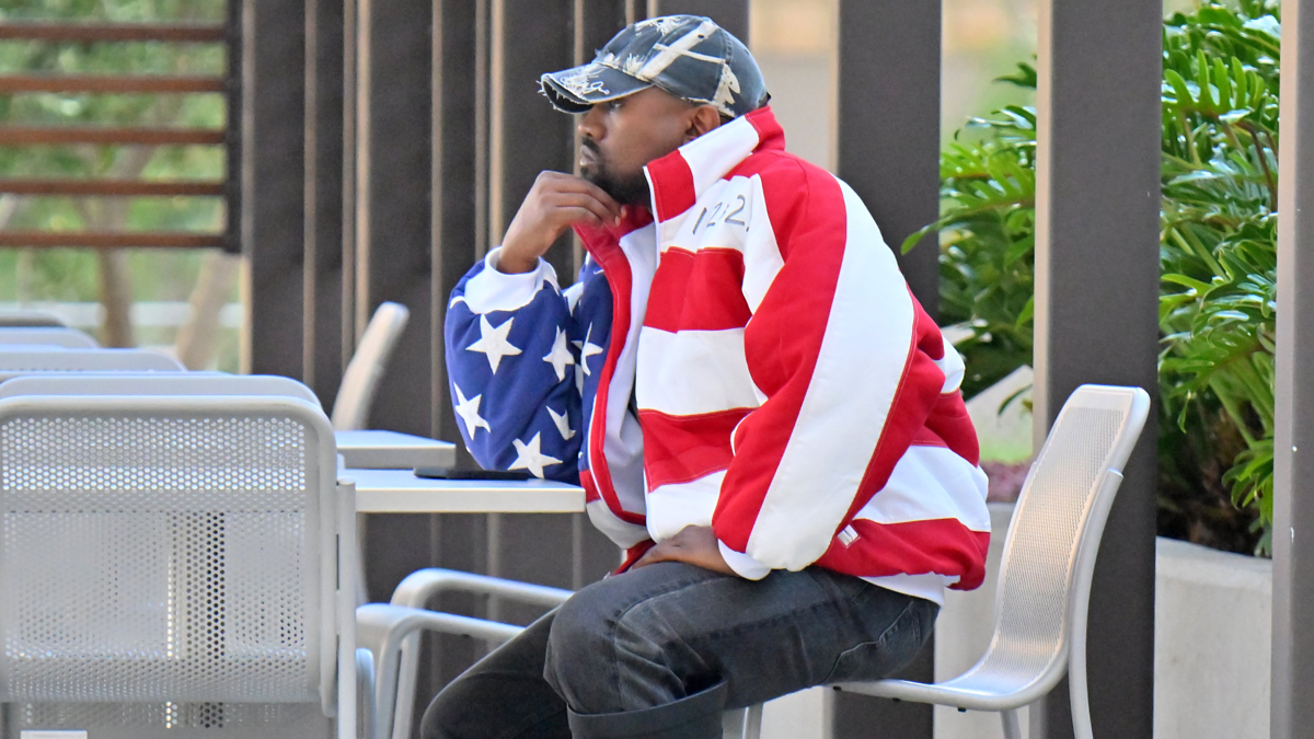 ye at a table wearing a flag jacket