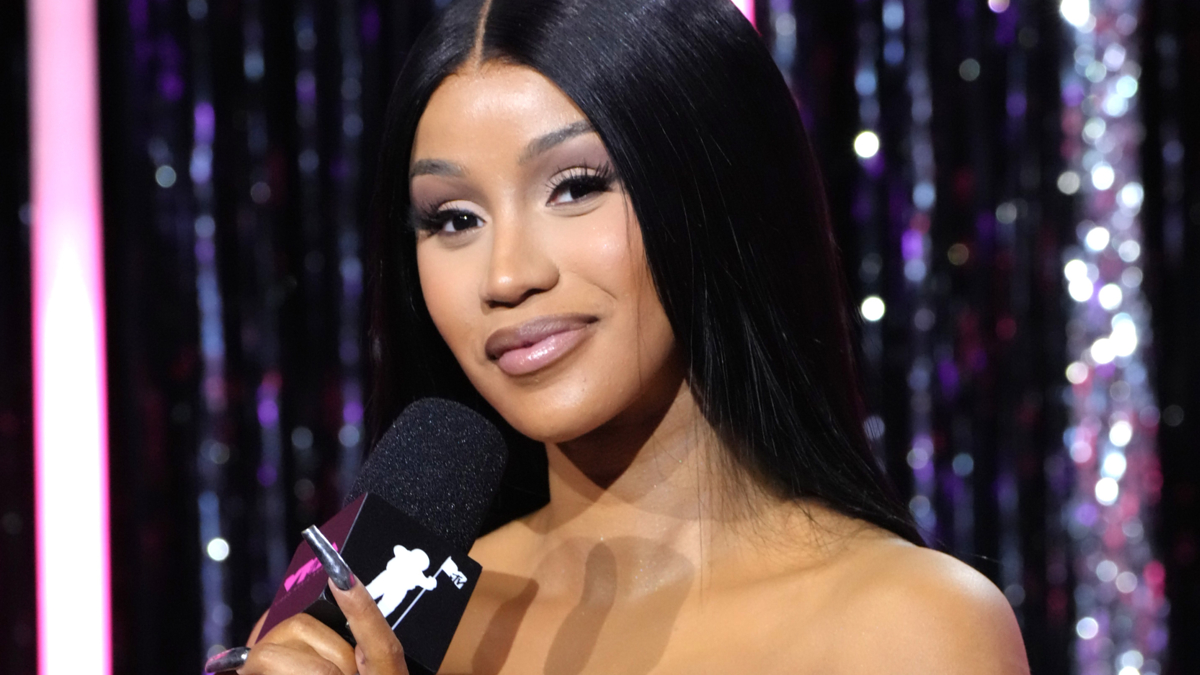 cardi b holding microphone