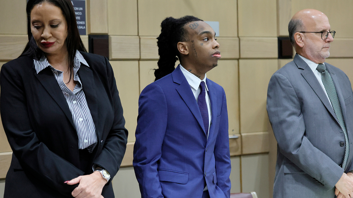 YNW Melly stands with his attorneys,Raven Ramona Liberty, left, and Stuart Adelstein, right, as jurors enter the courtroom for closing arguments in his trial