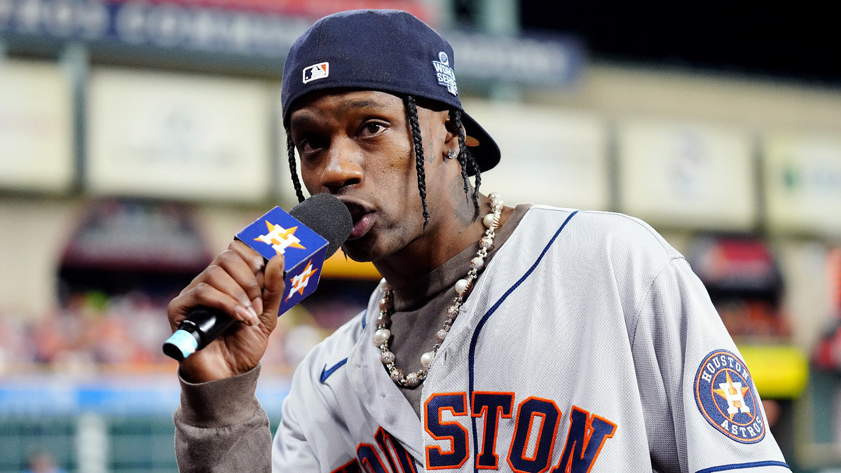 Travis Scott wearing Astros gear at game.
