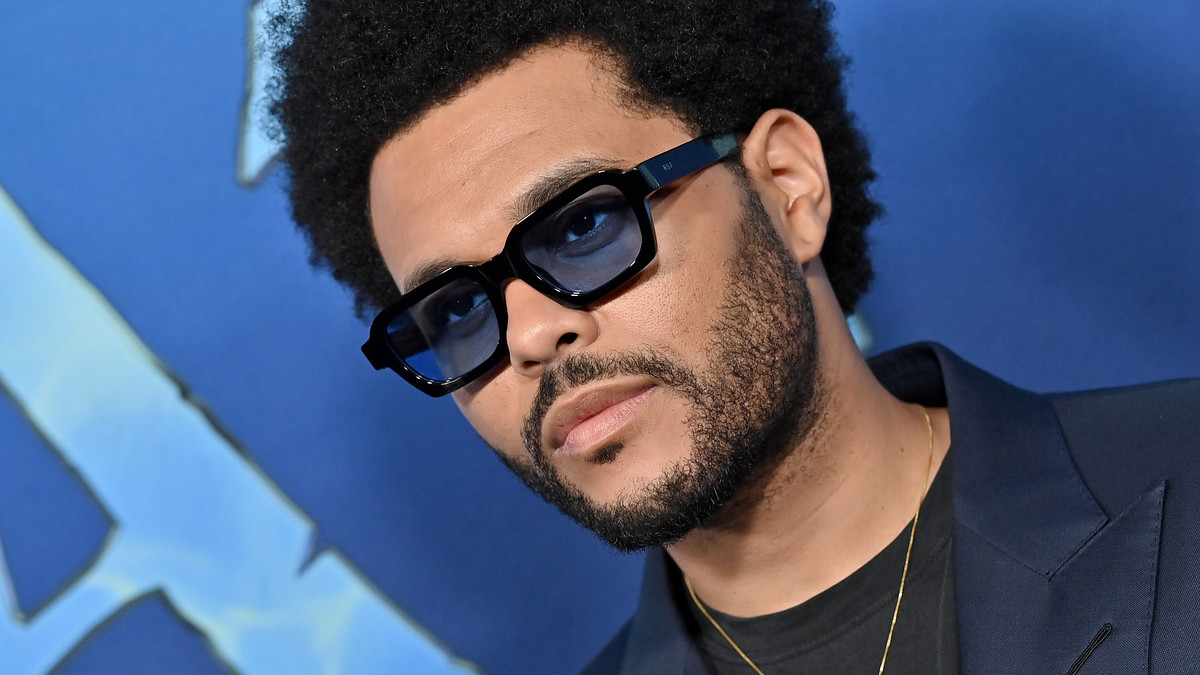 The Weeknd is seen on the blue carpet