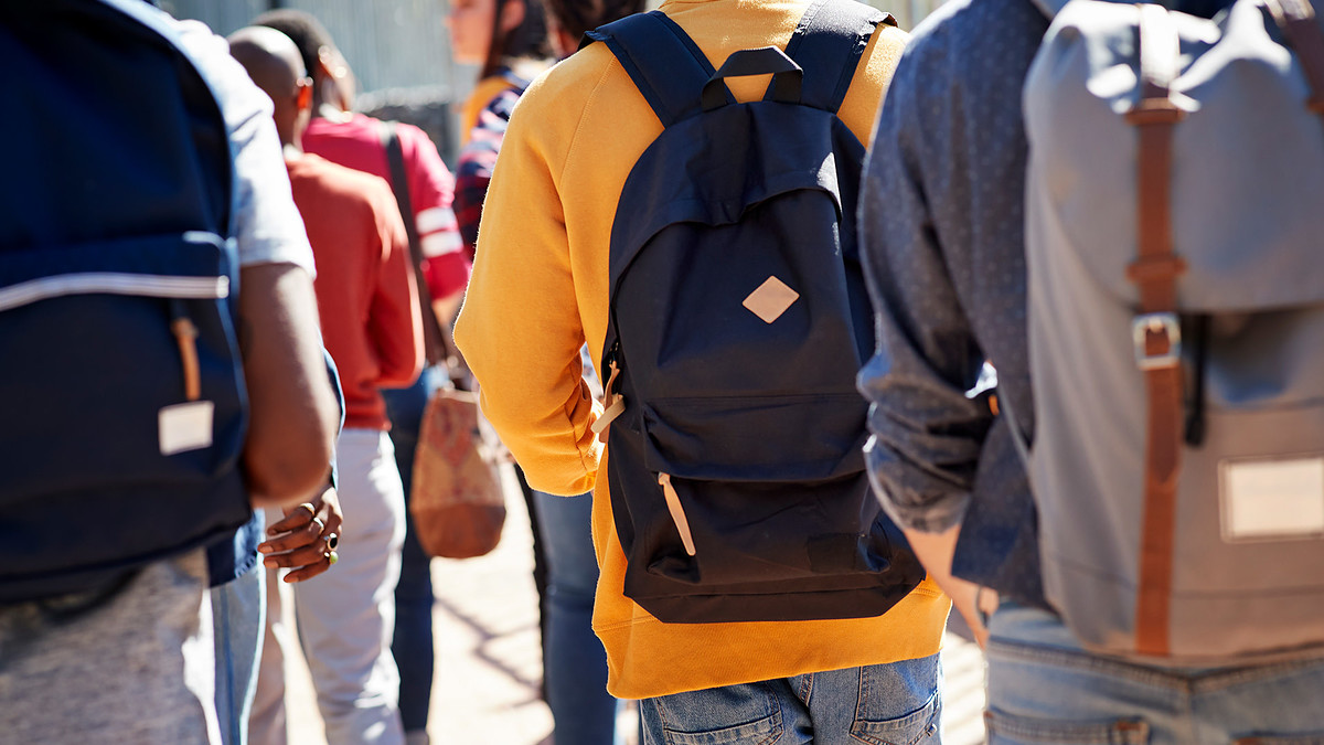 Male and female students walking at campus