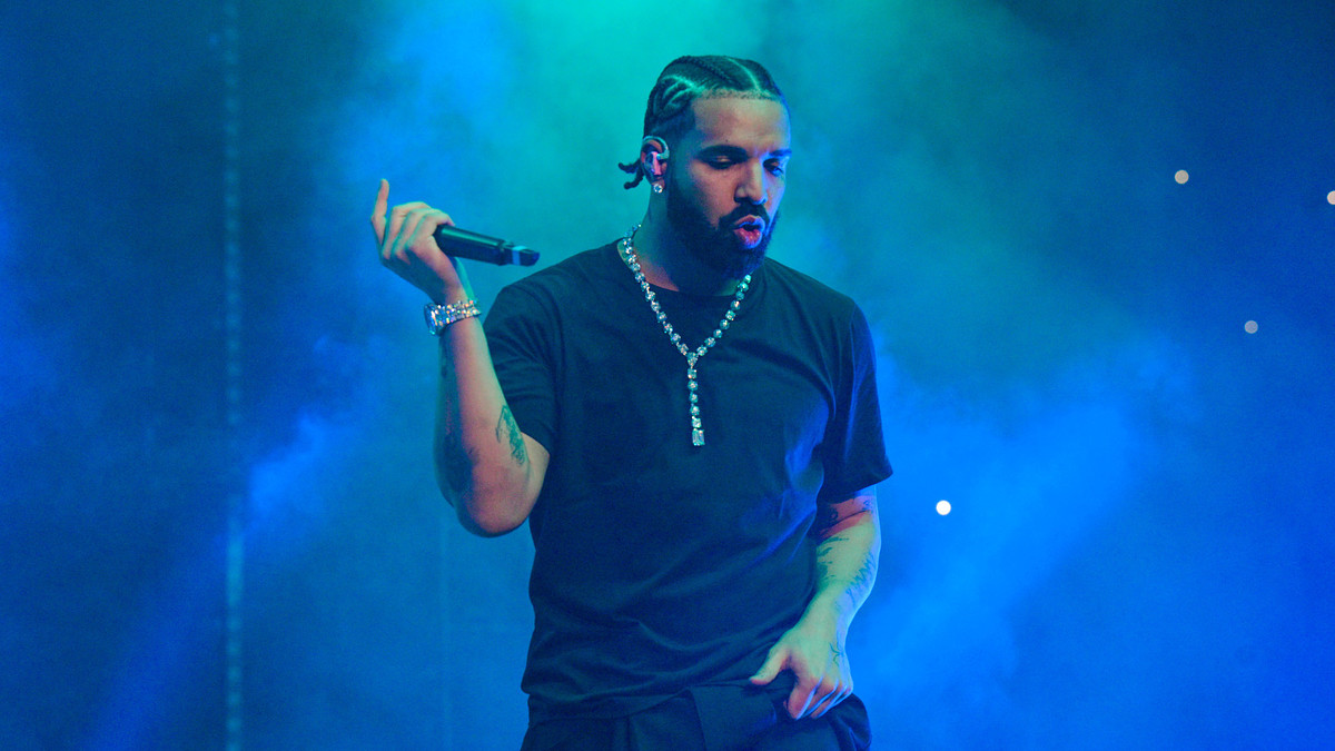 Drake performing live holding microphone