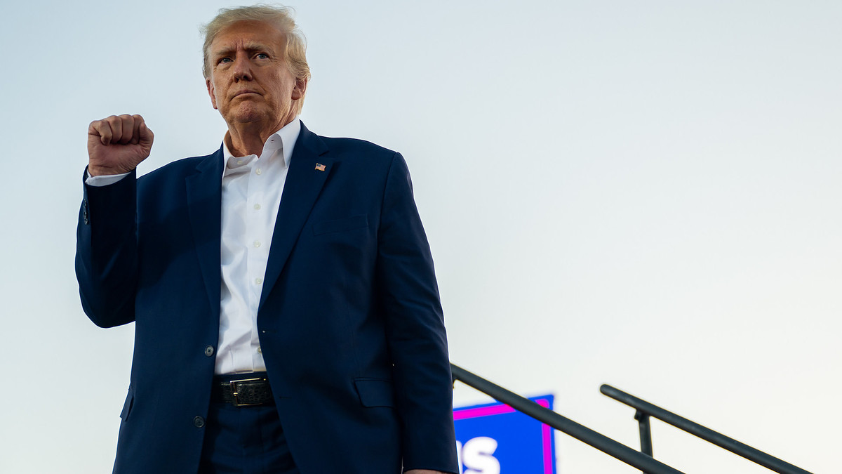 Donald Trump standing and making a face