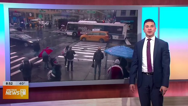 A weatherman is seen giving a report
