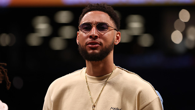 Ben Simmons looks on from the bench against the Detroit Pistons.