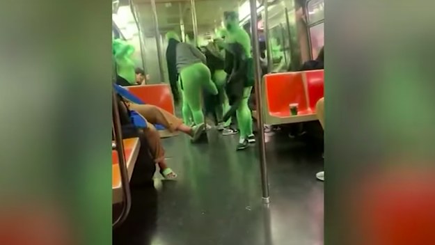 A screenshot from a viral video showing greensuit attackers