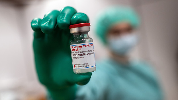 A doctor holds a jar of Moderna's vaccine against Covid 19