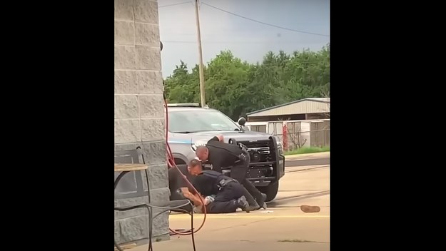A screenshot from a violent arrest video is shown