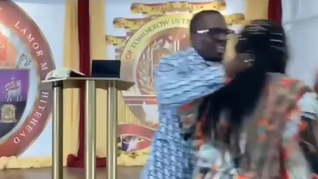 Bishop Lamor Whitehead grabbing a woman during a church service