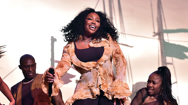 SZA onstage at a festival with dancers