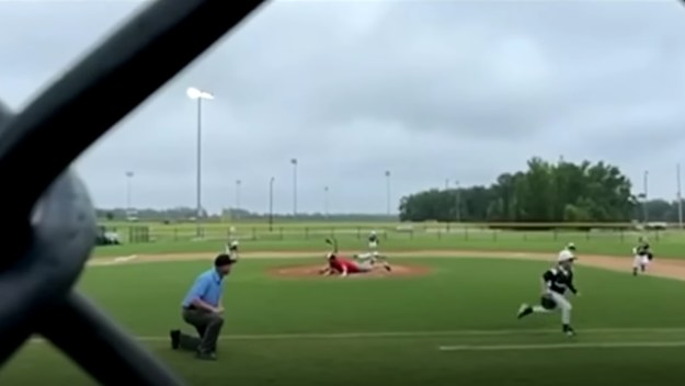 Little leaguers can be seen running for cover after gunfire erupts during game.