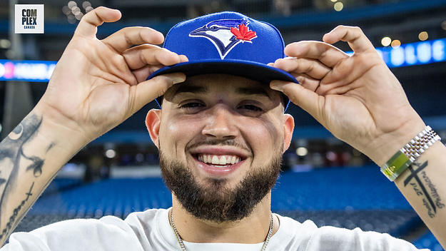 Toronto Blue Jays pitcher Alek Manoah poses with jays hat