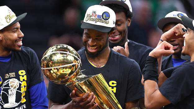 Andrew Wiggins holds the Larry O'Brien trophy