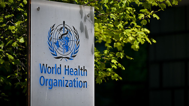 A picture taken on May 8, 2021 shows a sign of the World Health Organization (WHO) at the entrance