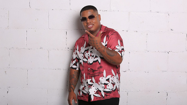 Smiley wearing a red button up with Playboy bunnies on it
