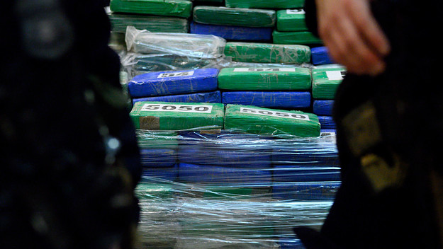 Guards stand in front of part of the evidence from a cocaine bust.