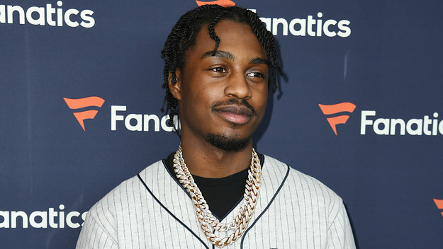 Lil Tjay smiling on a red carpet