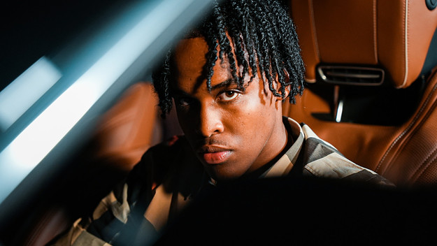 Ottawa rapper TwoTiime sitting in a car.