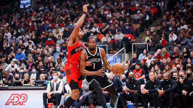 Kevin Durant #7 of the Brooklyn Nets drives on Scottie Barnes #4 of the Toronto Raptors
