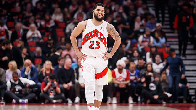 The Raptors' Fred Vanvleet smiles while standing on the court