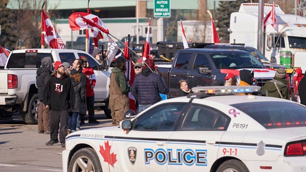 Protestors against Covid-19 vaccine mandates block the roadway at the Ambassador Bridge