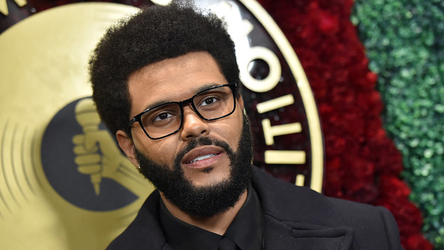 The Weeknd is pictured smiling at a camera