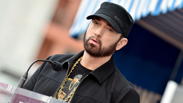 Eminem is pictured wearing a hat