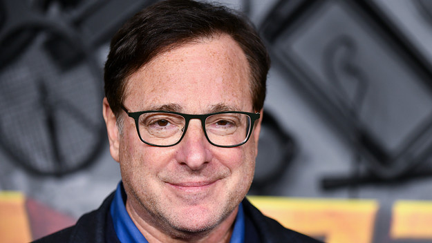 Bob Saget attends red carpet premiere event.