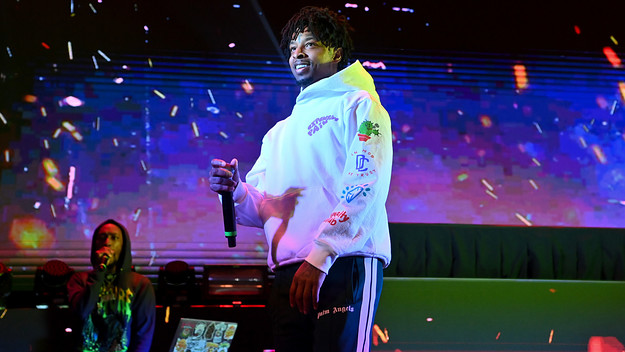 21 Savage smiles while performing live